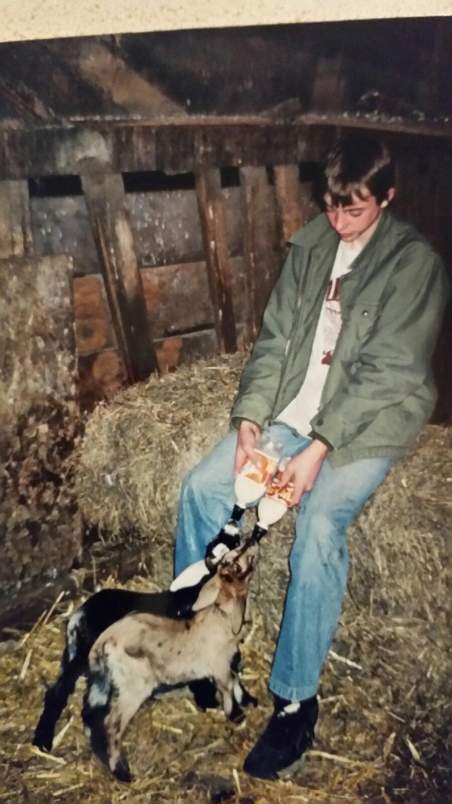 Bottle feeding 2 goats baby goats. I was around 13 in this pic as well. 